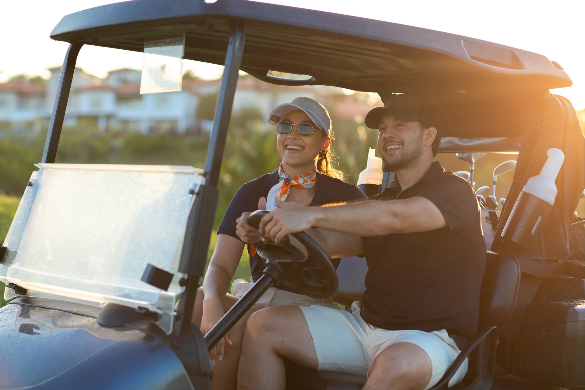 Couple riding a golf cart at The Black Pearl in Roatán