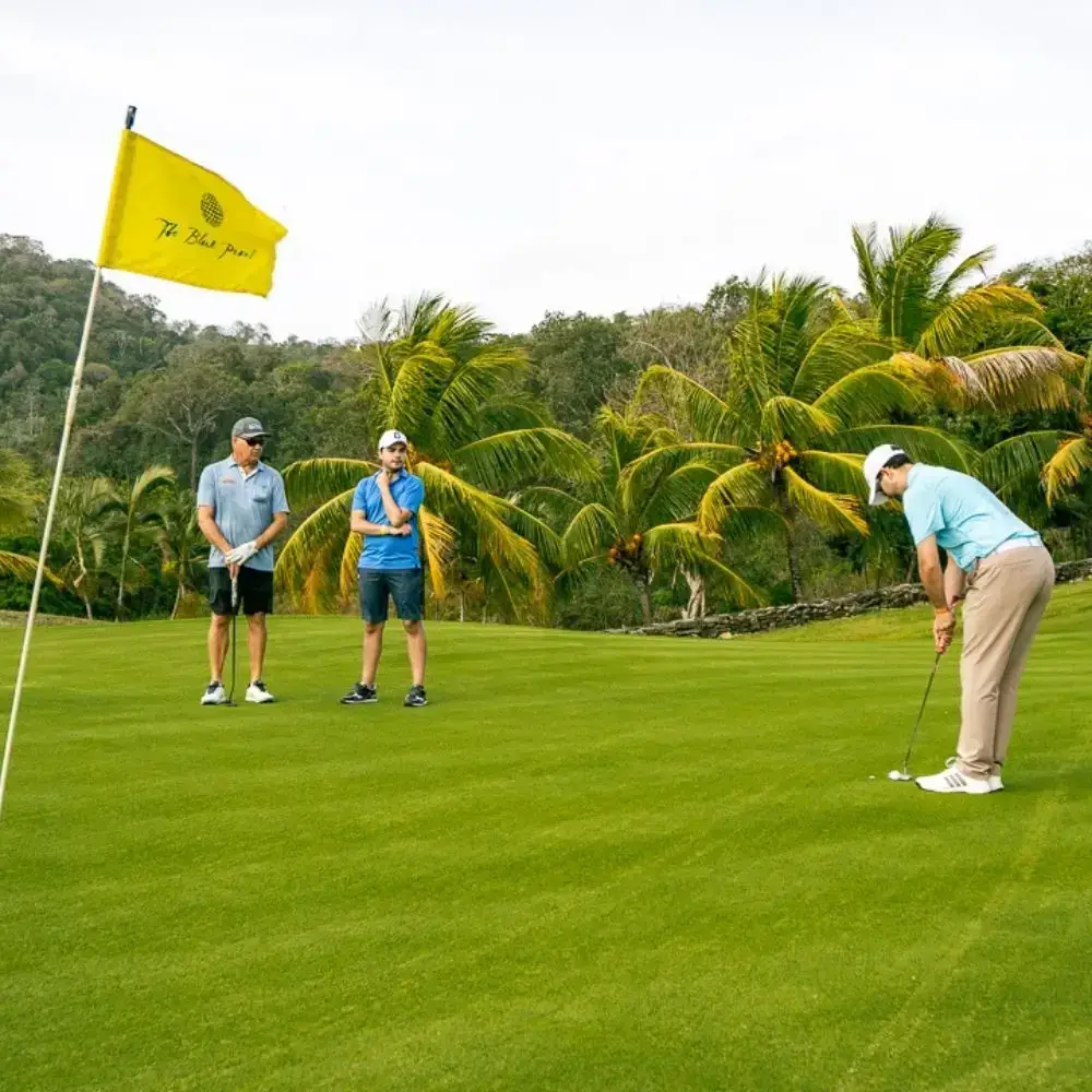 Golfers putting on a green at The Black Pearl