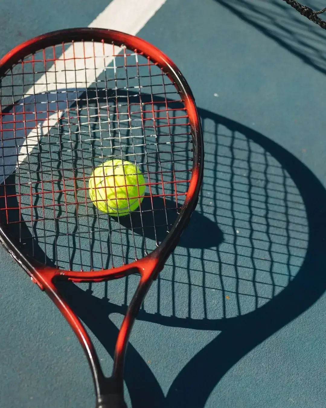 Tennis racquet and ball on a court